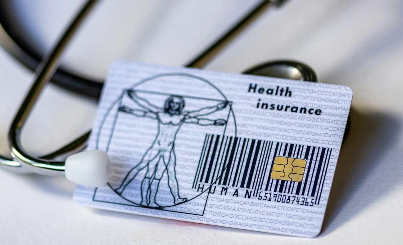 PSU employee reviewing private health insurance policy and medical bills